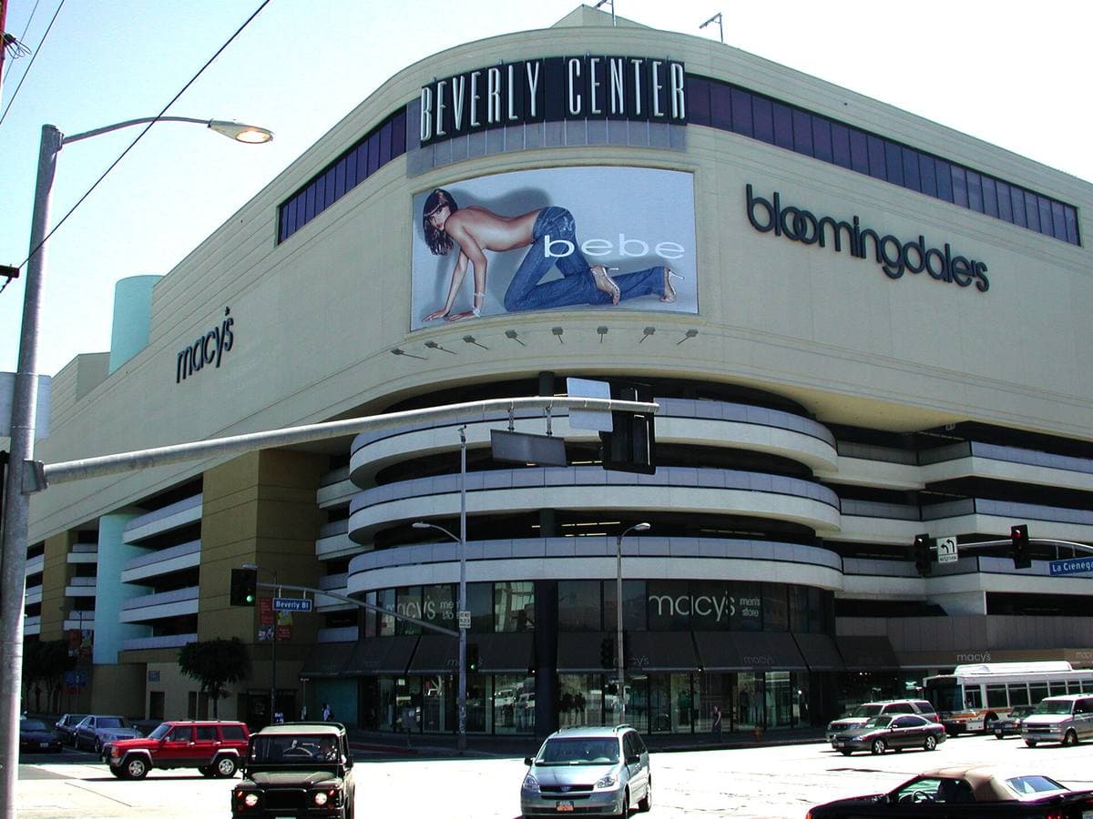 A tall windowless mall building with spiral parking ramps and Macy's and Bloomingdale's signs