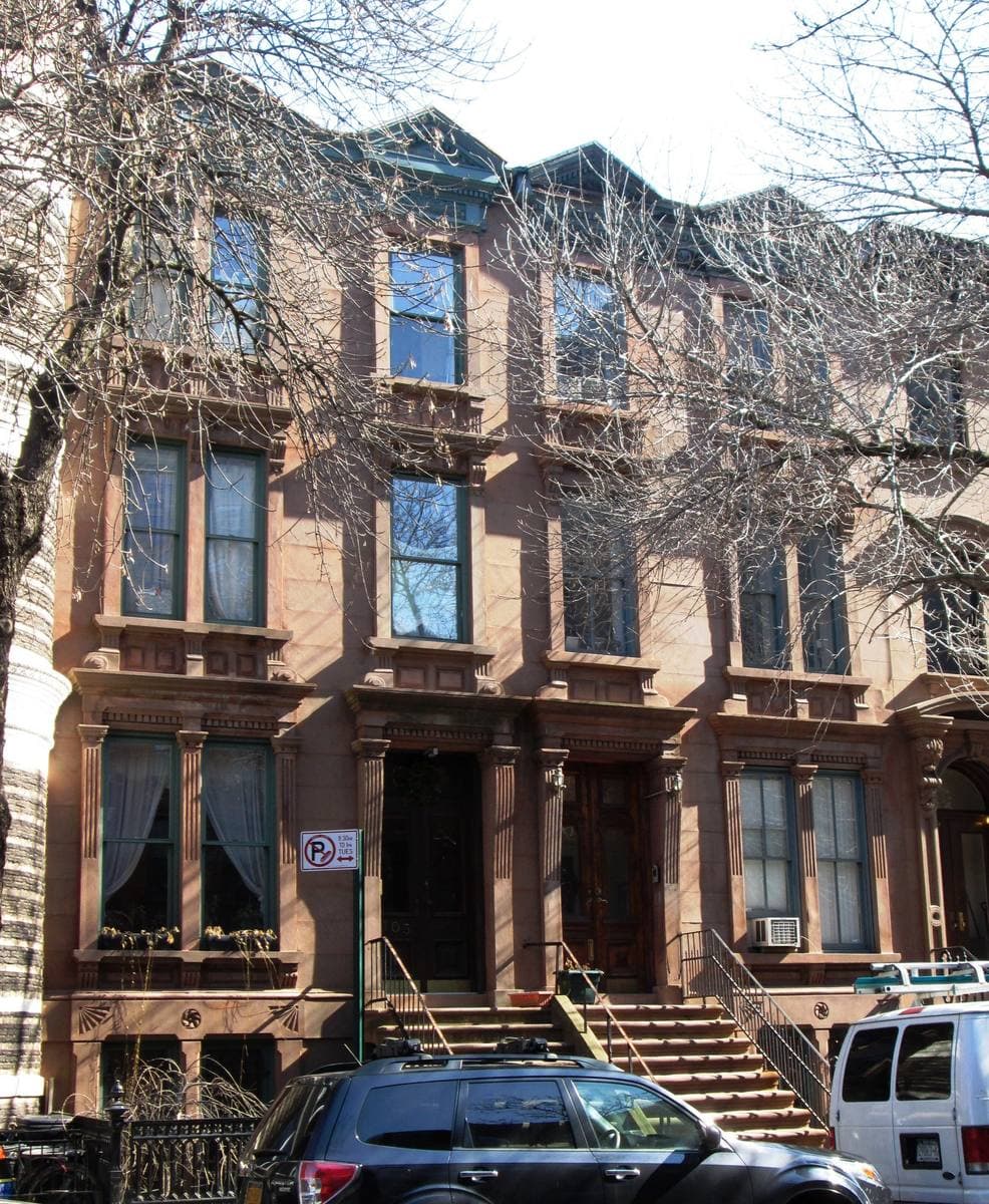 Two brownstone houses with stoops on South Elliott Place in winter