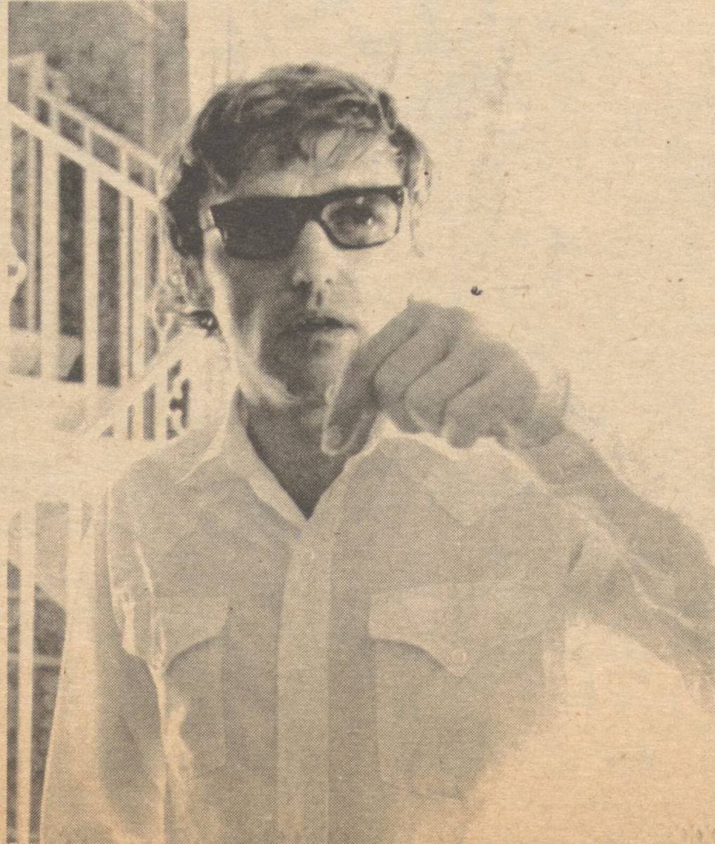 Dennis Hopper in dark glasses and a western shirt, gesturing as he talks