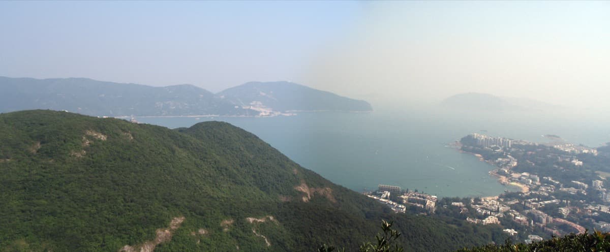 Panoramic view of Tai Tam Bay and its wooded shoreline.