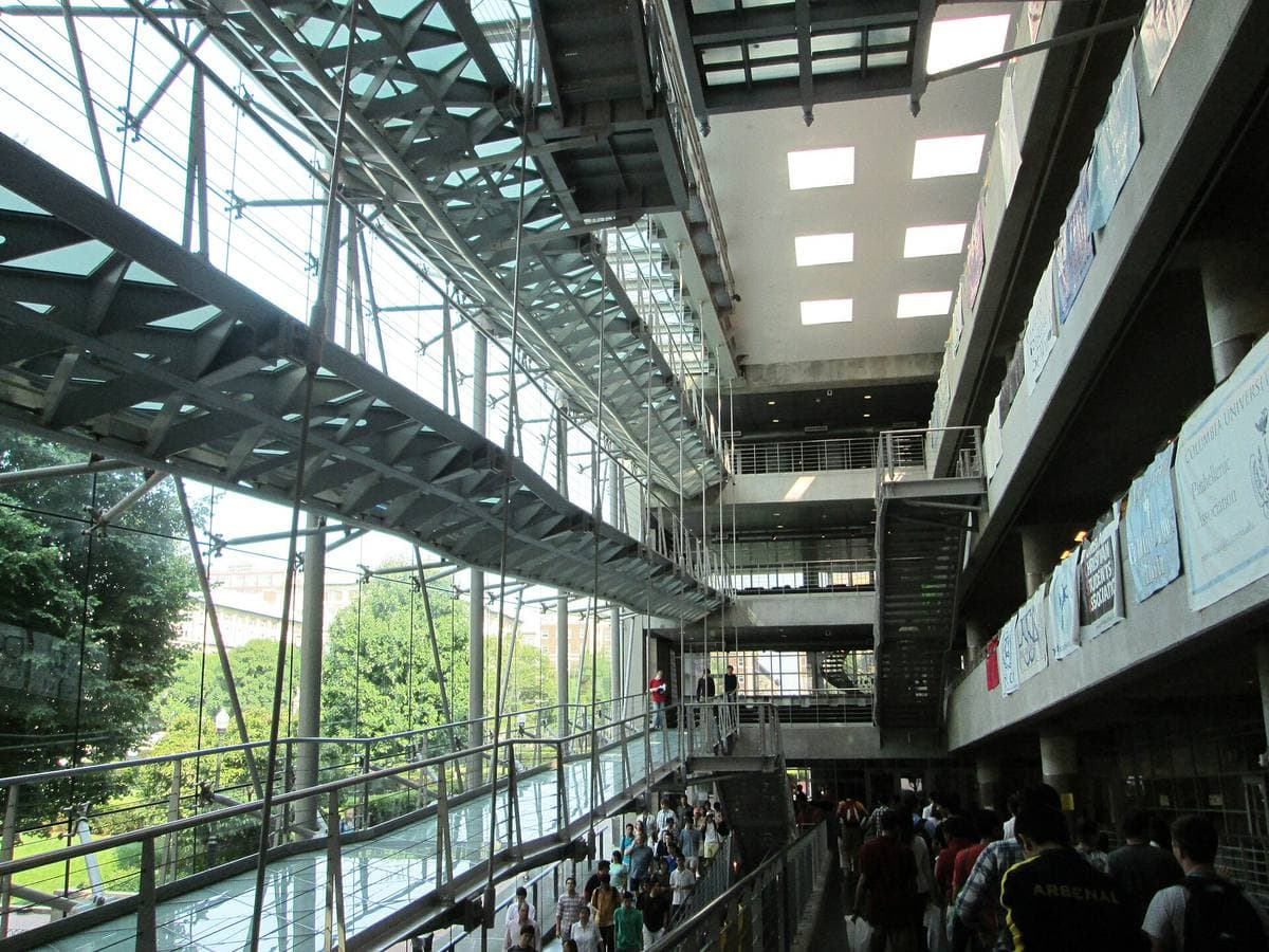 Glass ramps and steel beams inside a tall atrium