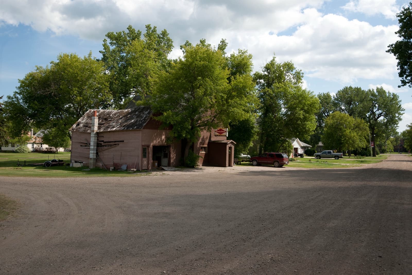 A gravel crossroads with a few old buildings and trees in Bathgate