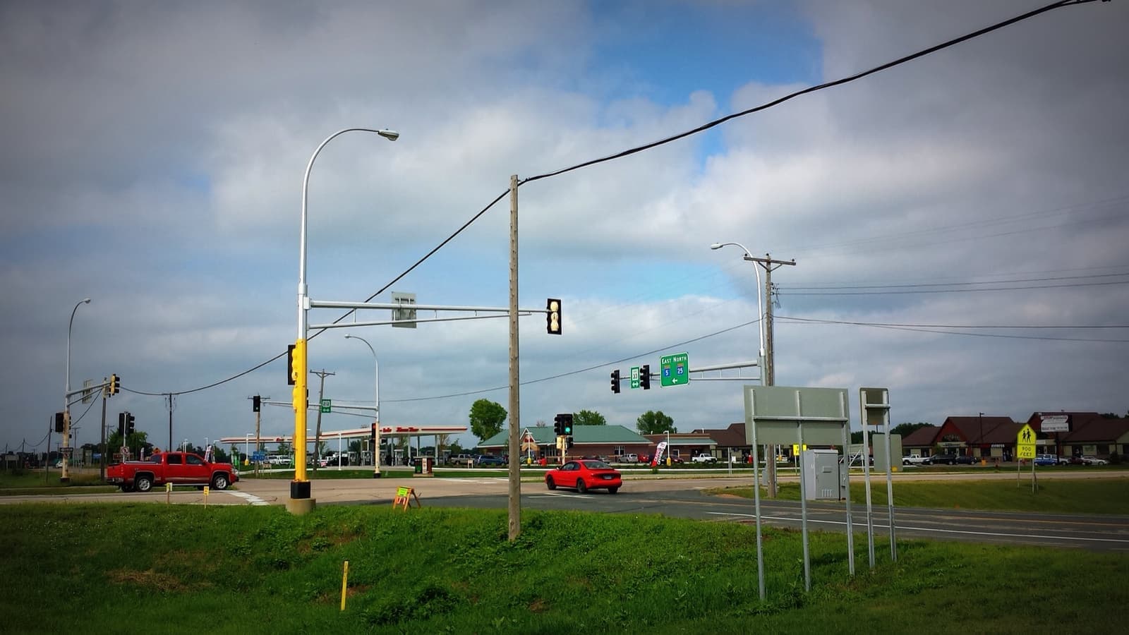 A flat crossroads with traffic lights and power lines on Highway 212