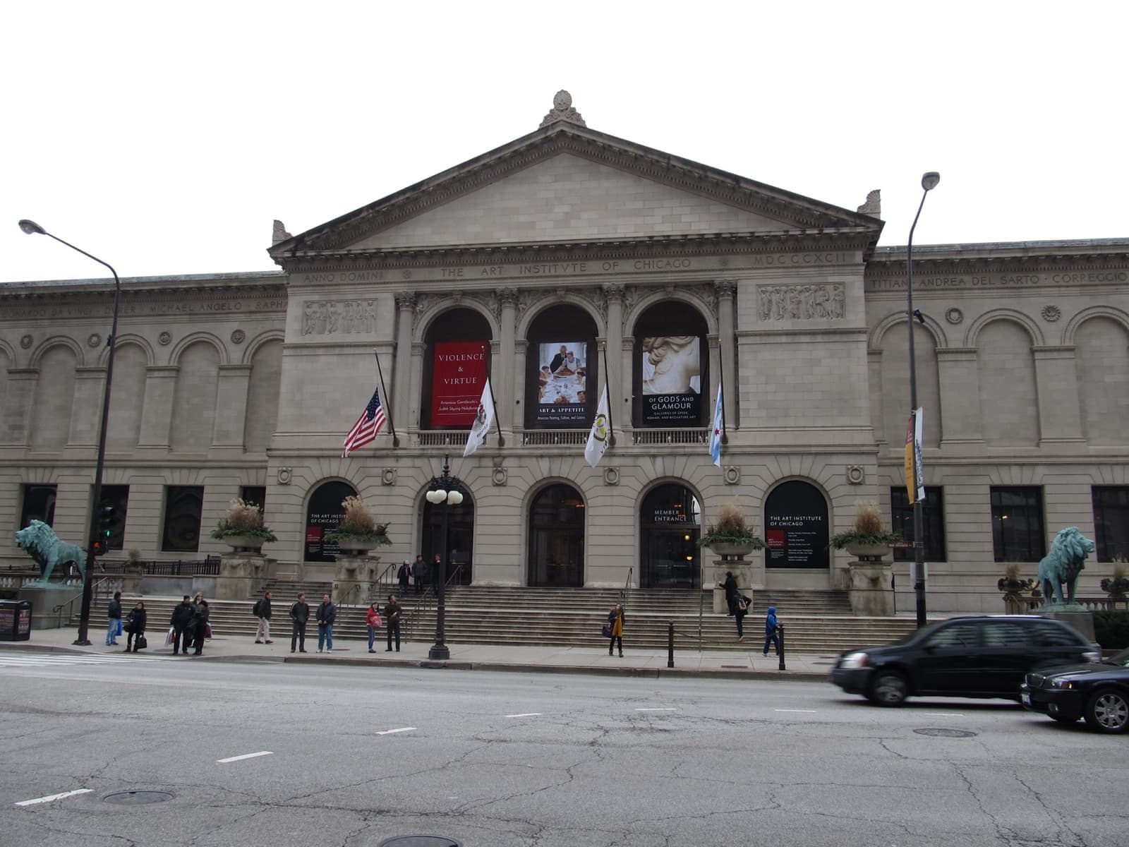 The classical stone front of the Art Institute of Chicago on Michigan Avenue, with banners and a bronze lion