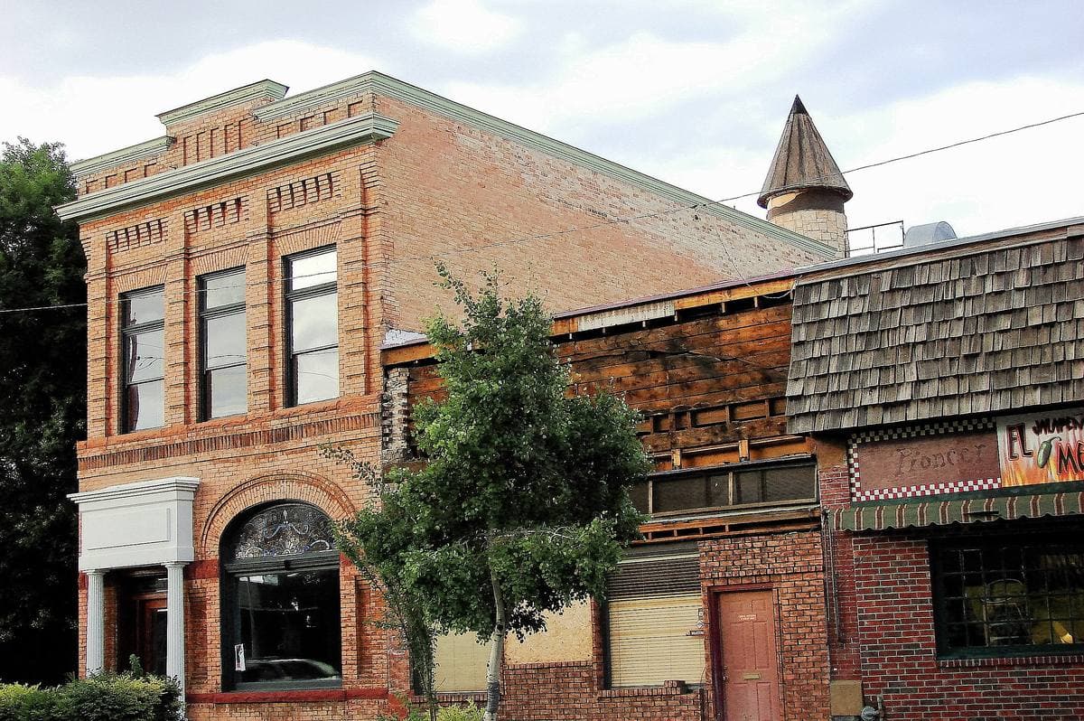 Red-brick and stone commercial buildings on a small-town main street