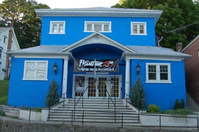 A small blue theatre front on a village main street