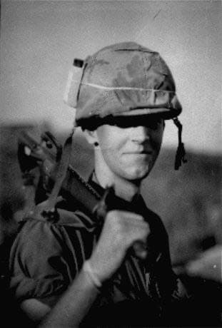 Gustav Hasford in a helmet and fatigues, black and white