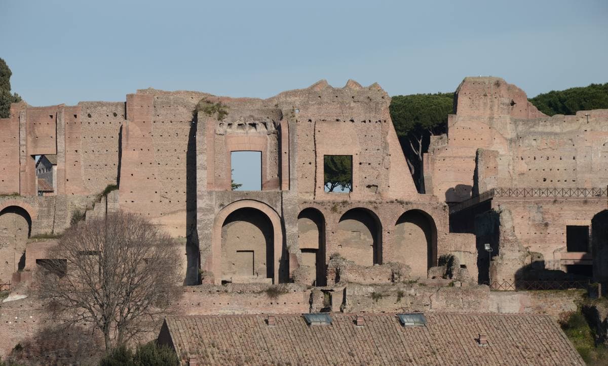 High brick walls and arches of a ruined palace on a hill