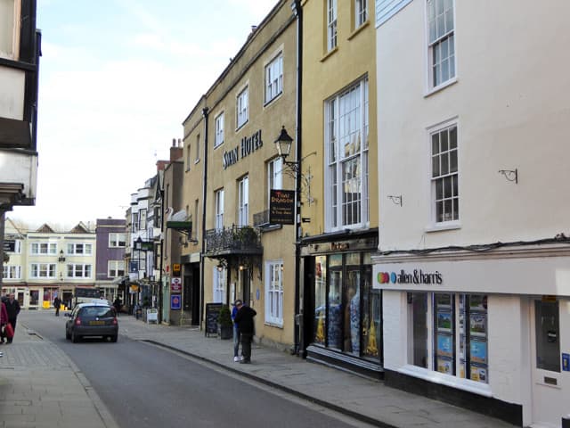 A long stone hotel front on a narrow street