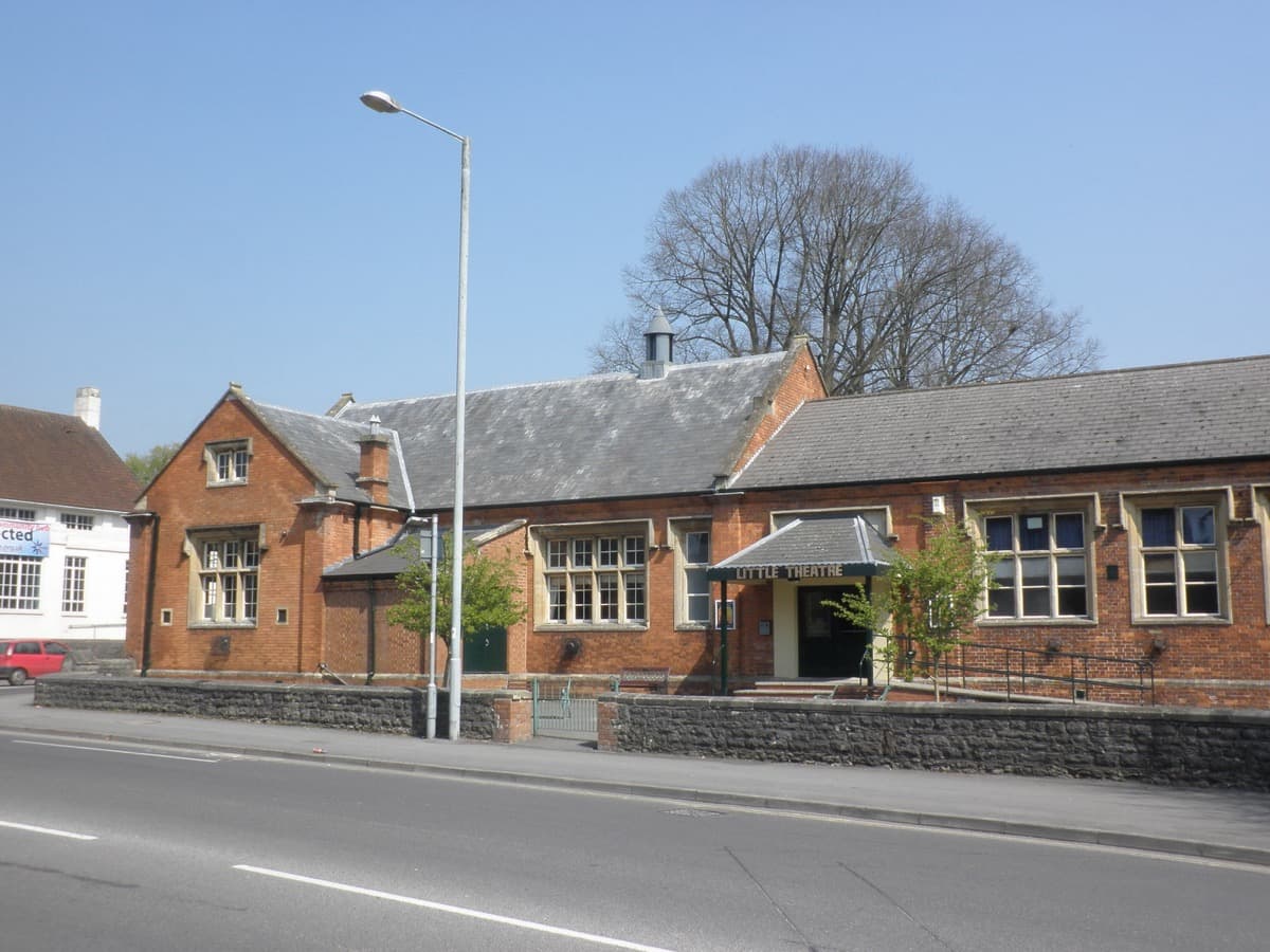 The front of a small theatre building on a street corner