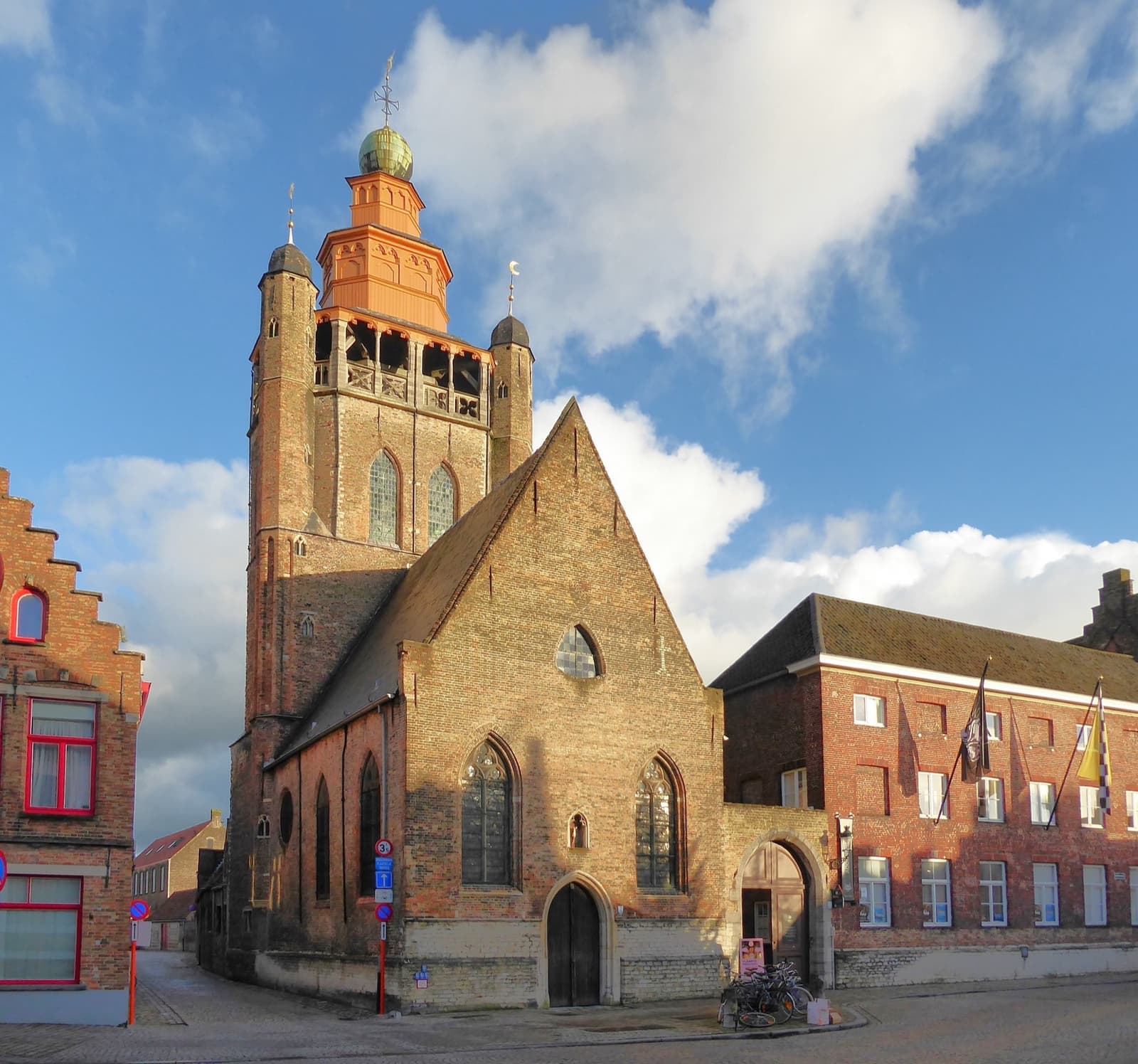 A brick chapel with a tall tower topped by an eastern-style lantern