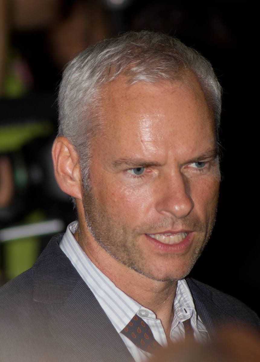 Martin McDonagh, grey-haired, in an open-necked shirt and dark jacket