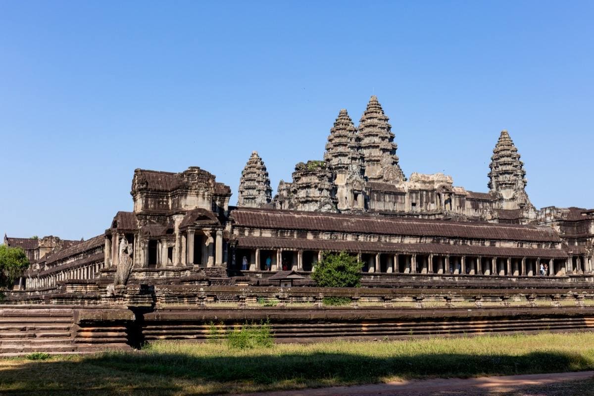 The five towers of Angkor Wat rising over a long stone gallery