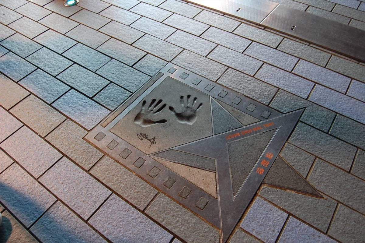 Two handprints cast in a bronze star set into paving