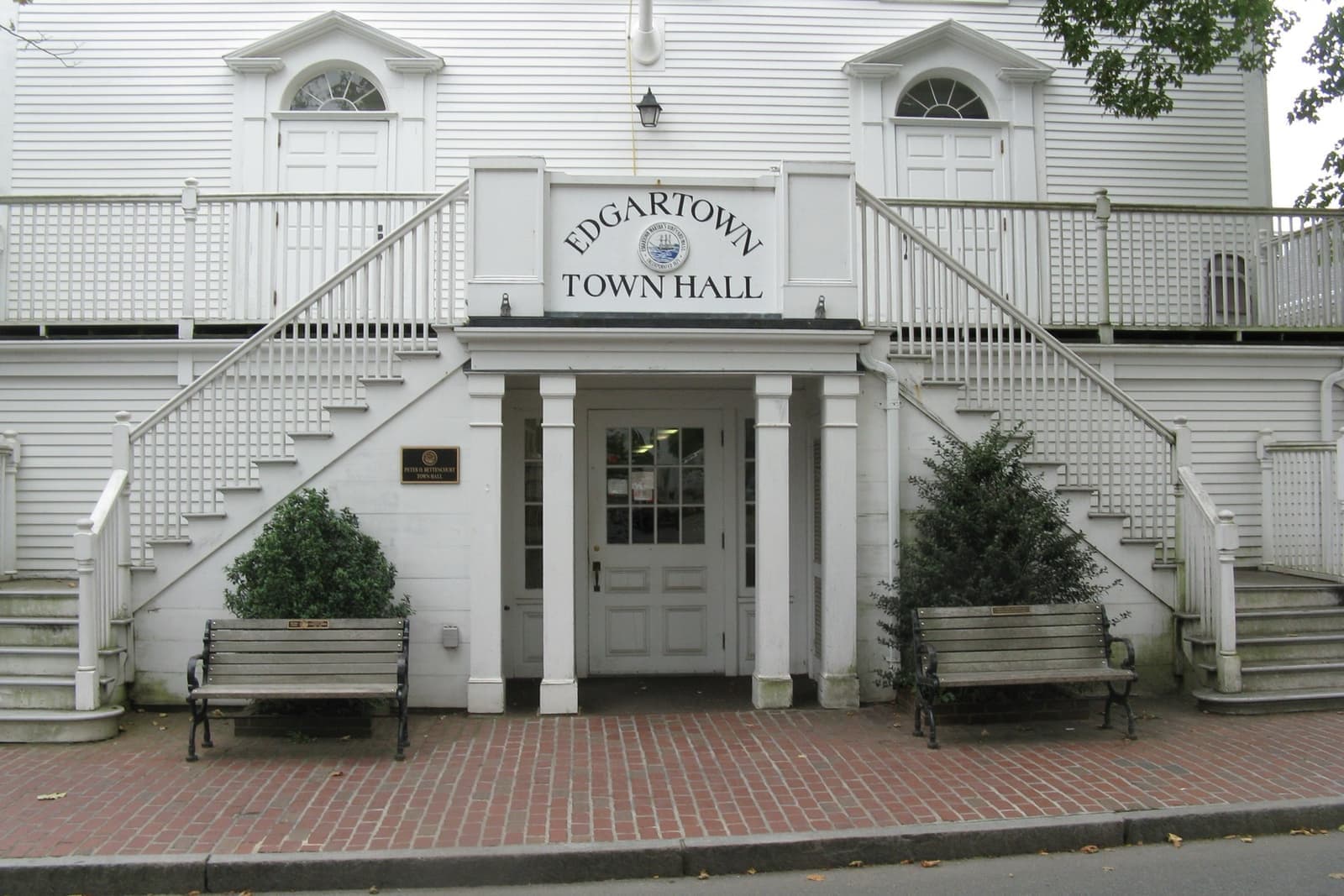 The white clapboard front of Edgartown Town Hall with twin outside staircases