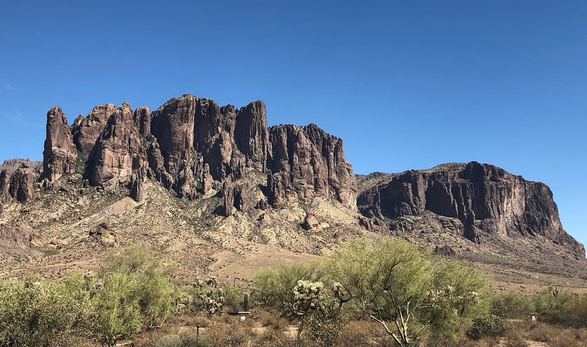 Desert scrub in front of the rocky Superstition Mountains