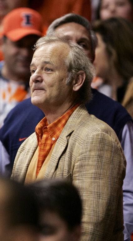 Bill Murray, grey-haired, in a tweed jacket and orange shirt, looking up and away