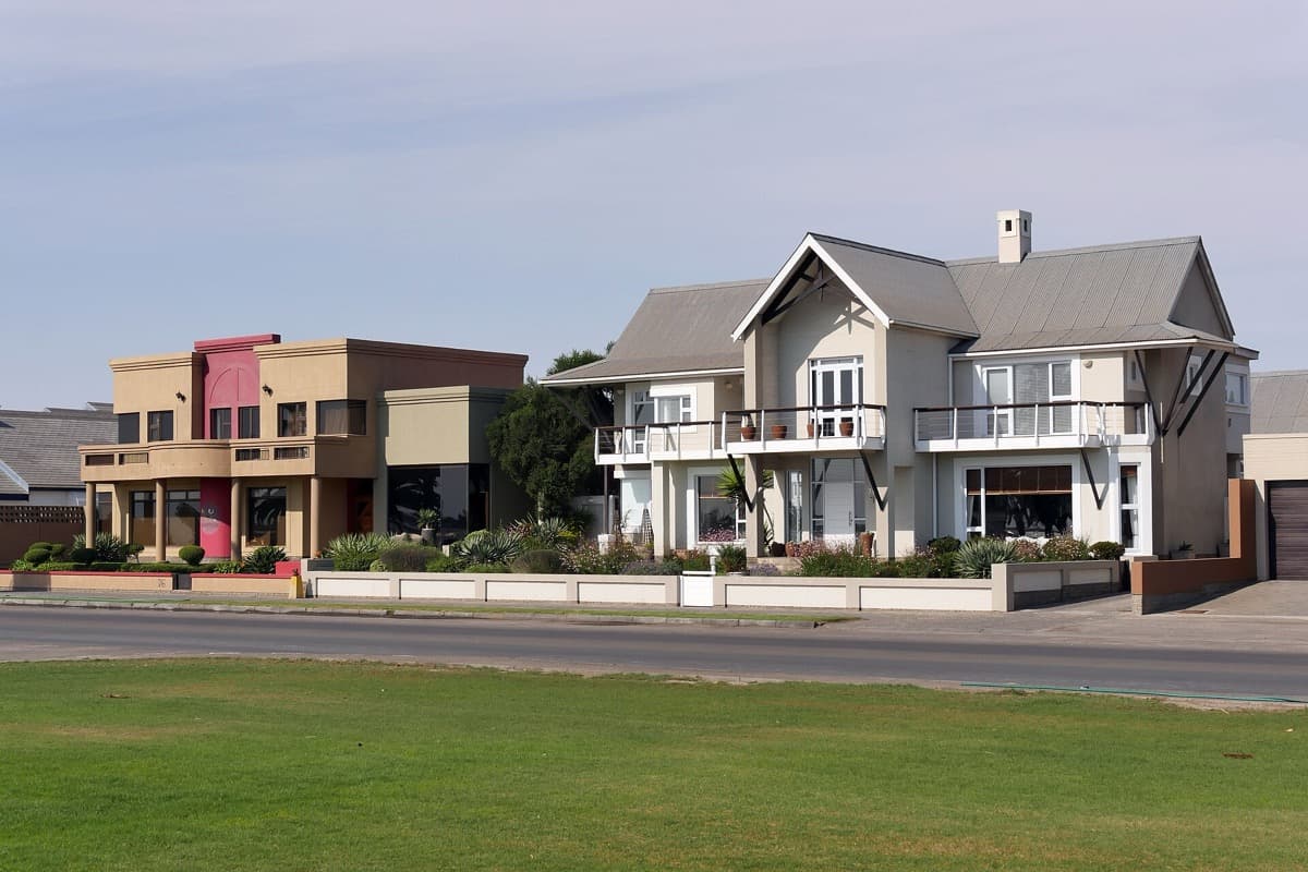 Low houses along a street in Swakopmund under a pale sky