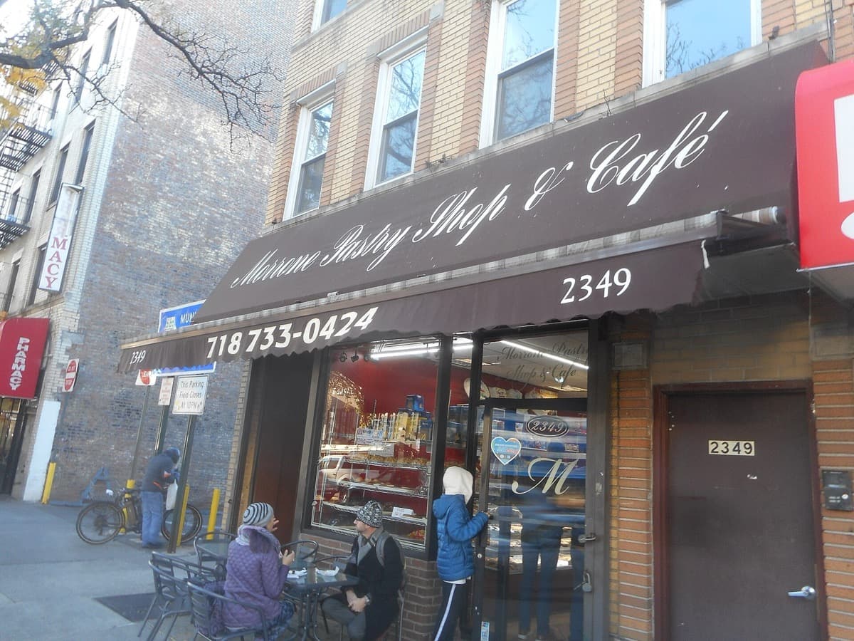 A pastry shop front on a Bronx shopping street