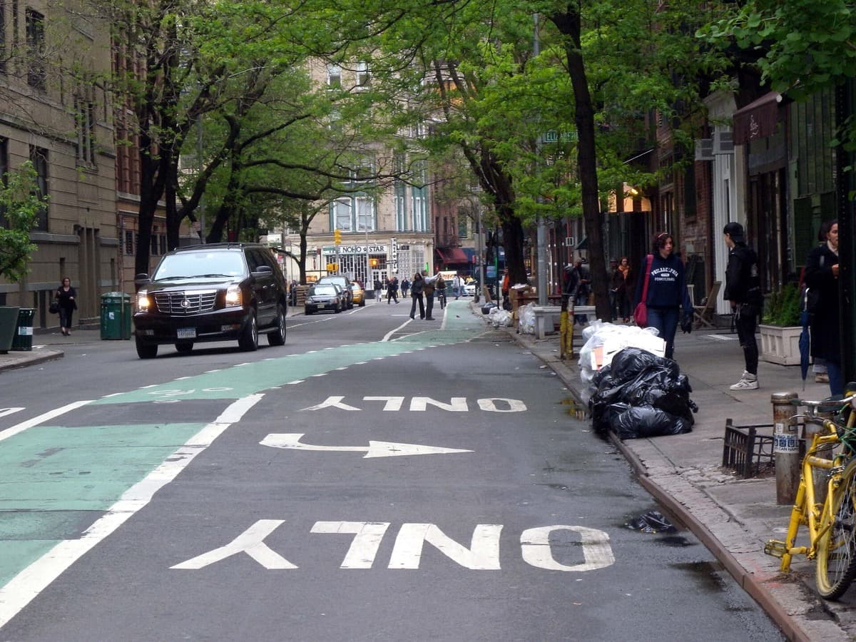 A street corner with low brick buildings and traffic lights