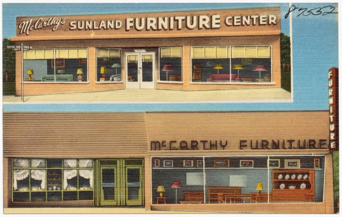 A linen postcard of a two-storey furniture shop with big windows on Foothill Boulevard