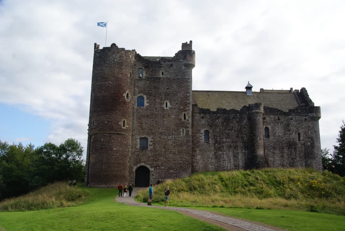 The high stone walls and tower of Doune Castle.