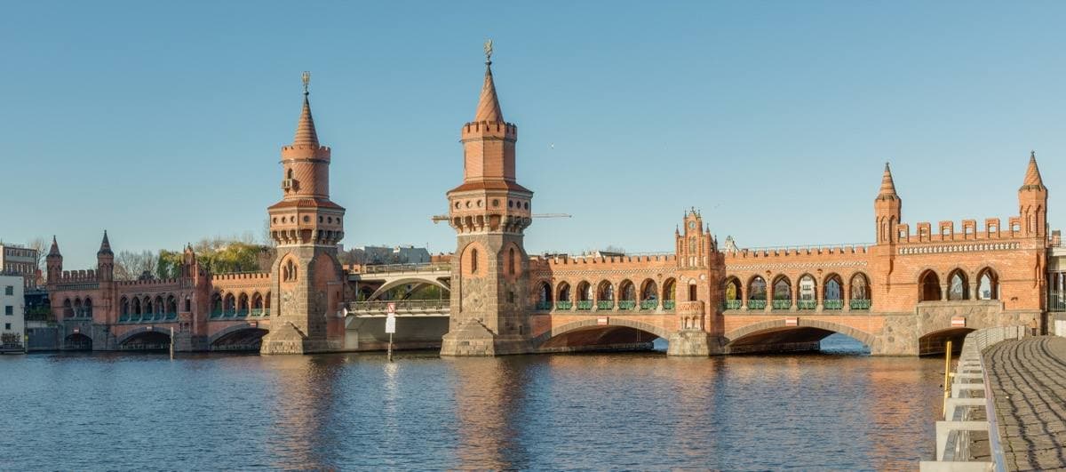 The Oberbaum Bridge's brick arches and turrets reflected in the river