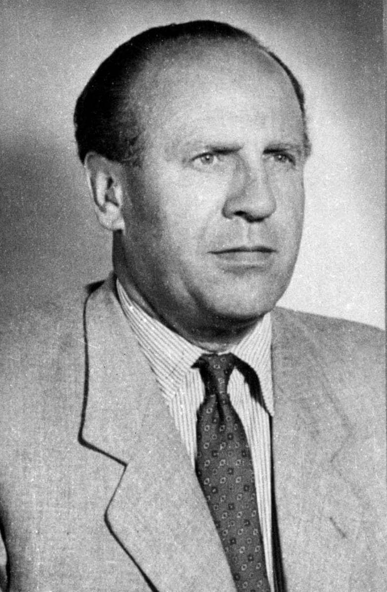 A black-and-white portrait of a man in a suit and tie