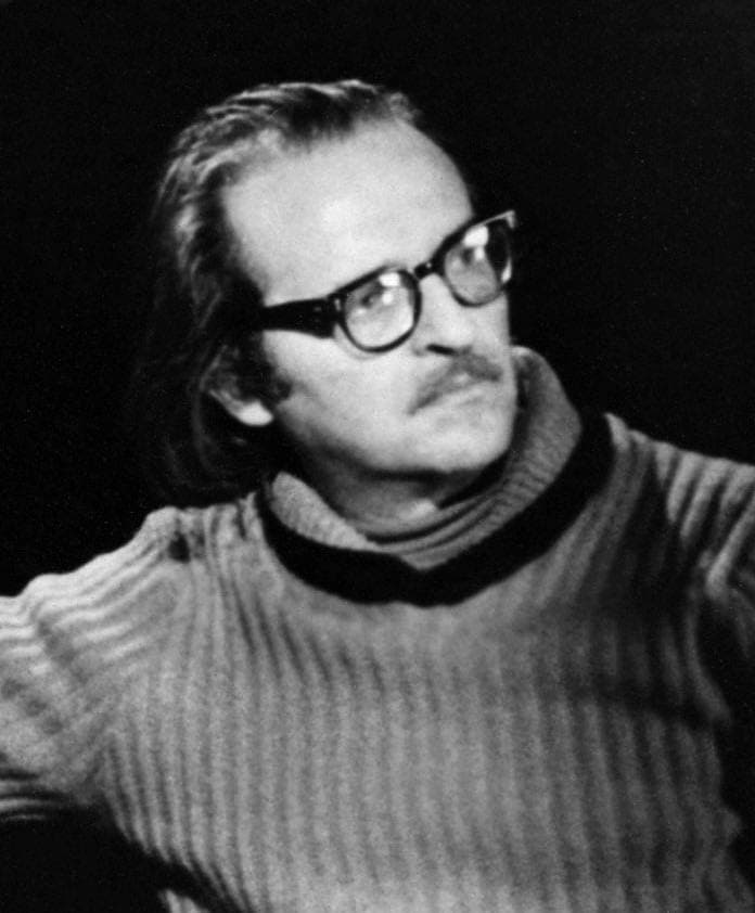 Sidney Lumet in glasses, mid-conversation