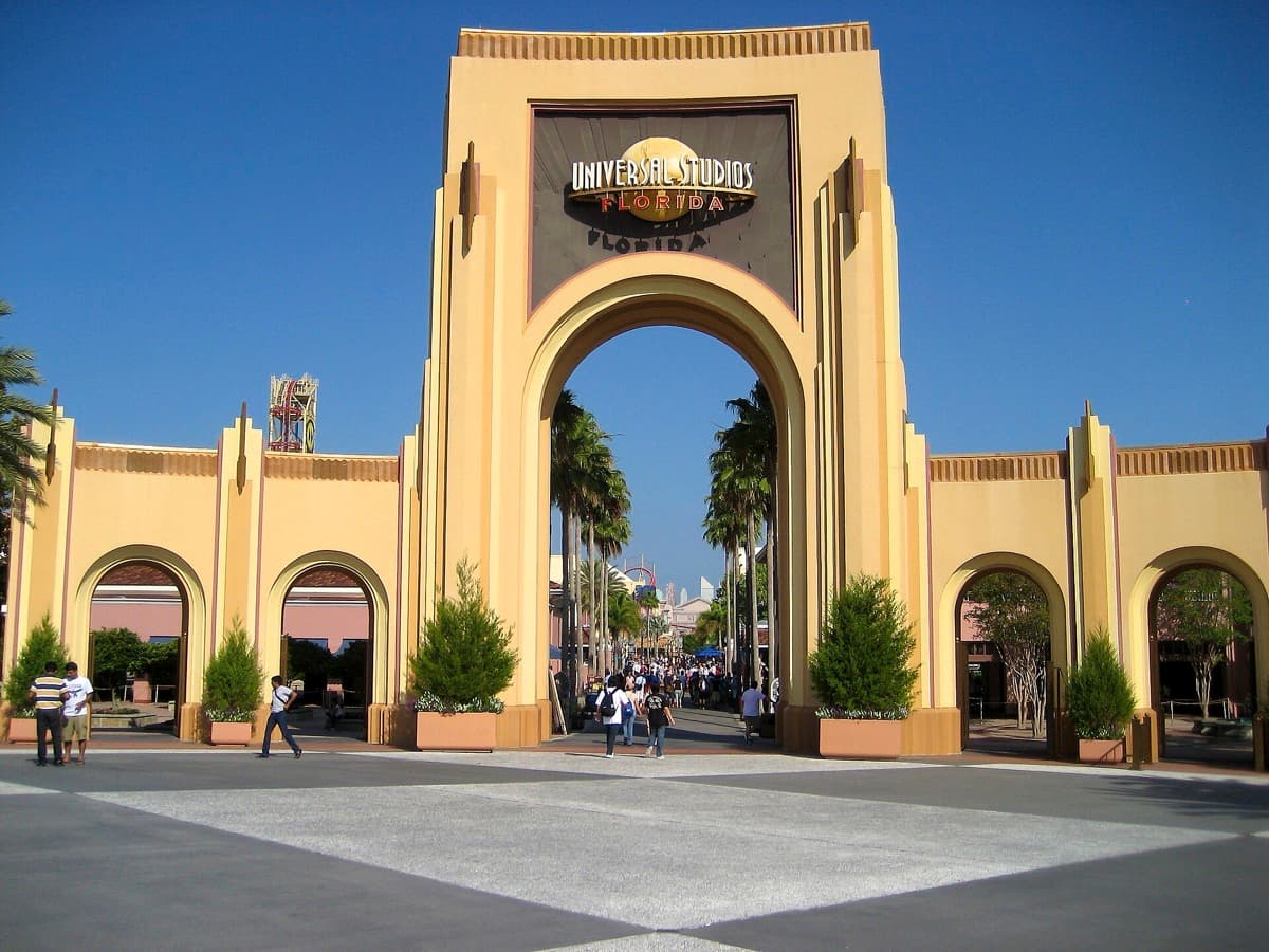 A park entrance gate with a globe and banners
