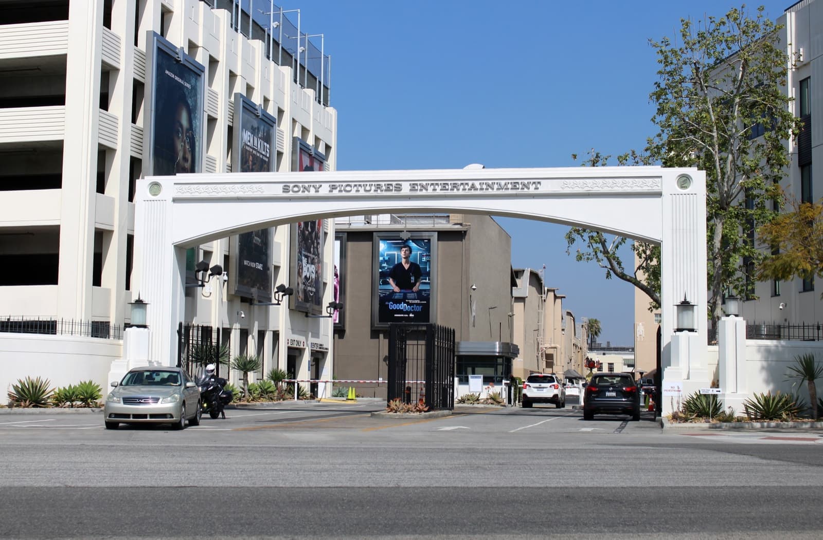 A studio gate with a guard booth and palm trees