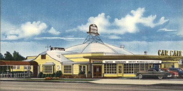 A colour postcard of a low cream restaurant with a dome and a sign reading Car Cafe