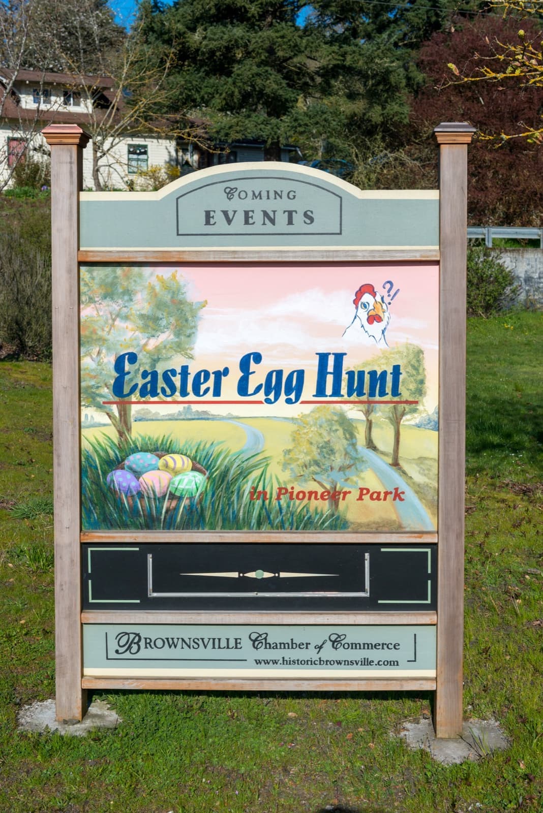 A painted Brownsville Chamber of Commerce events board advertising an Easter egg hunt in Pioneer Park