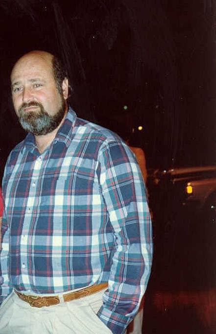 Rob Reiner with a grey beard in a checked shirt