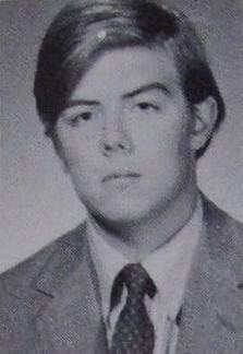 John Hughes as a teenager in jacket and tie, a school portrait, black and white