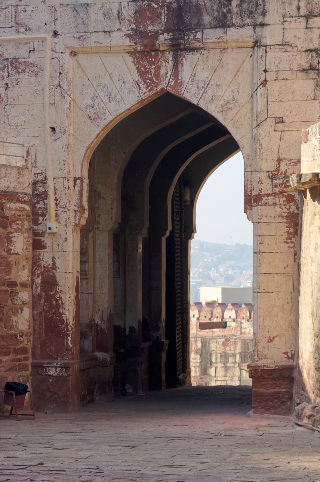 A towering sandstone gateway with high walls