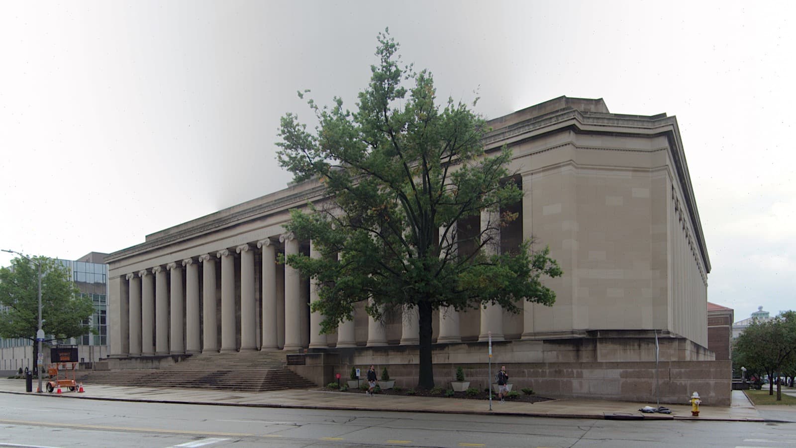 A long classical building lined with tall stone columns