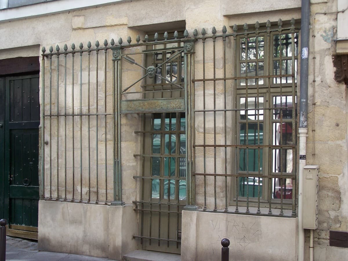 A narrow Paris street of stone buildings