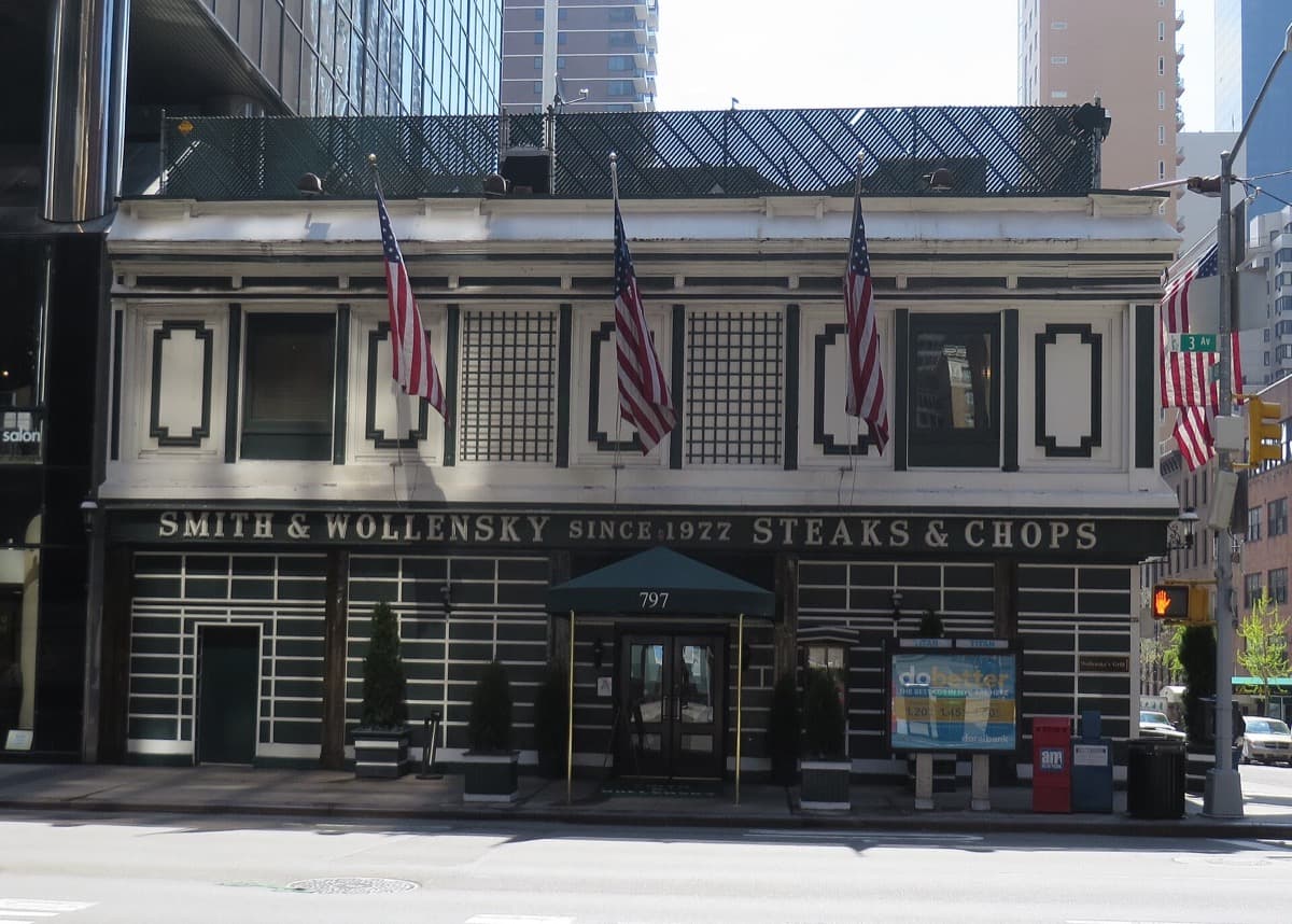 A steakhouse with a green-and-white corner exterior