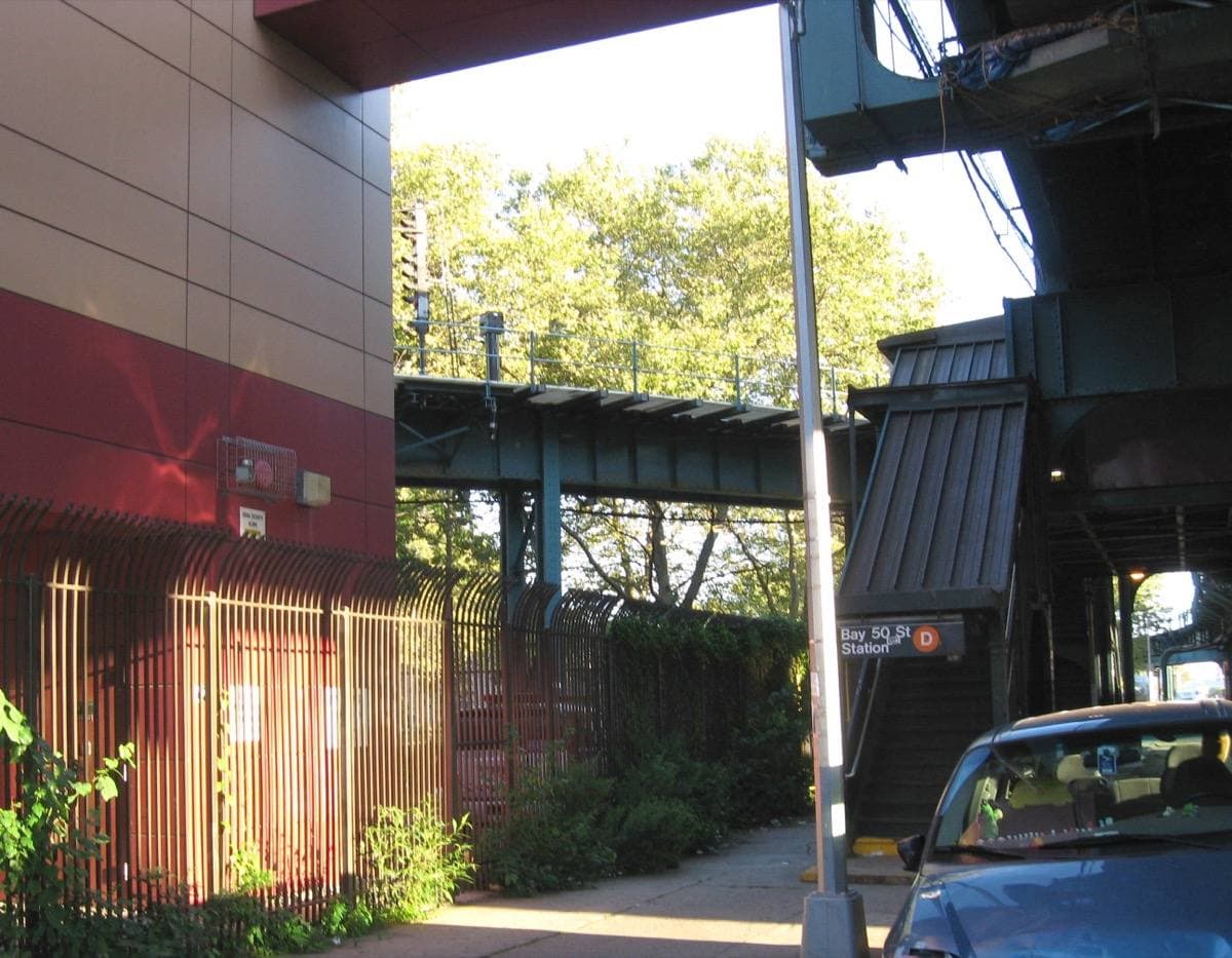 Elevated station structure above a street with trees