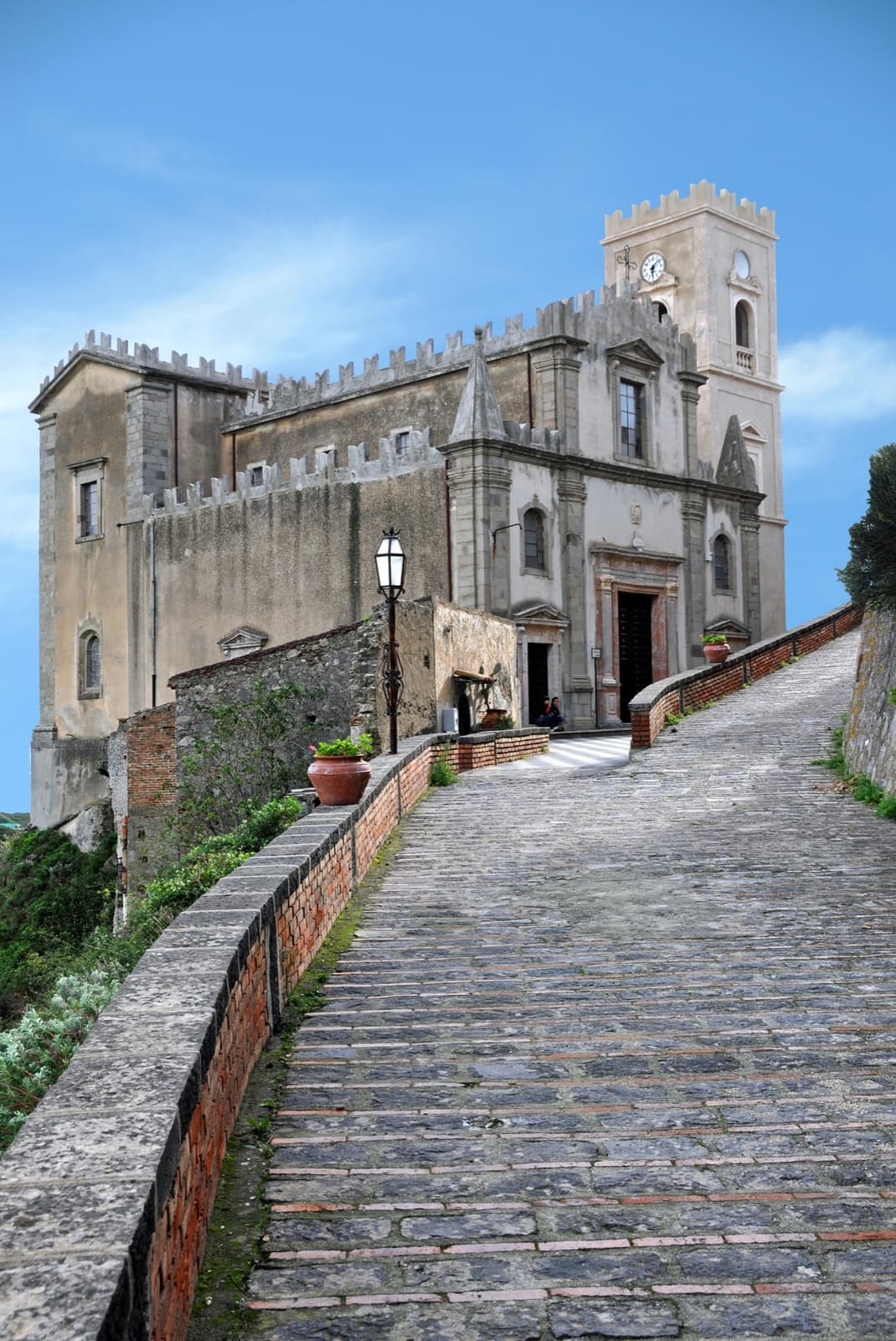 A stone church with a fortified front on a rocky ridge