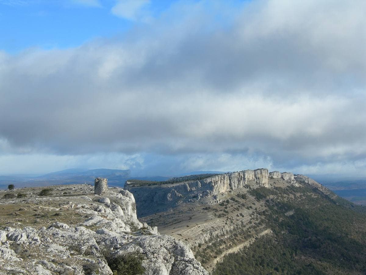 Limestone cliffs and a lookout above a wide valley under cloud