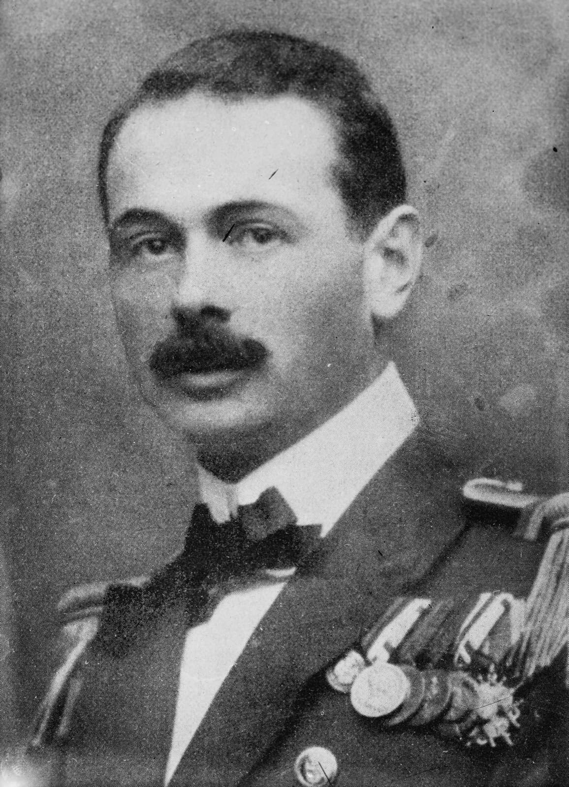 A moustached naval officer in uniform with medals