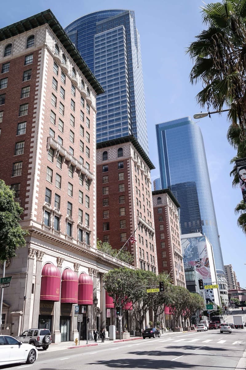 A tall stone hotel facade seen from the street