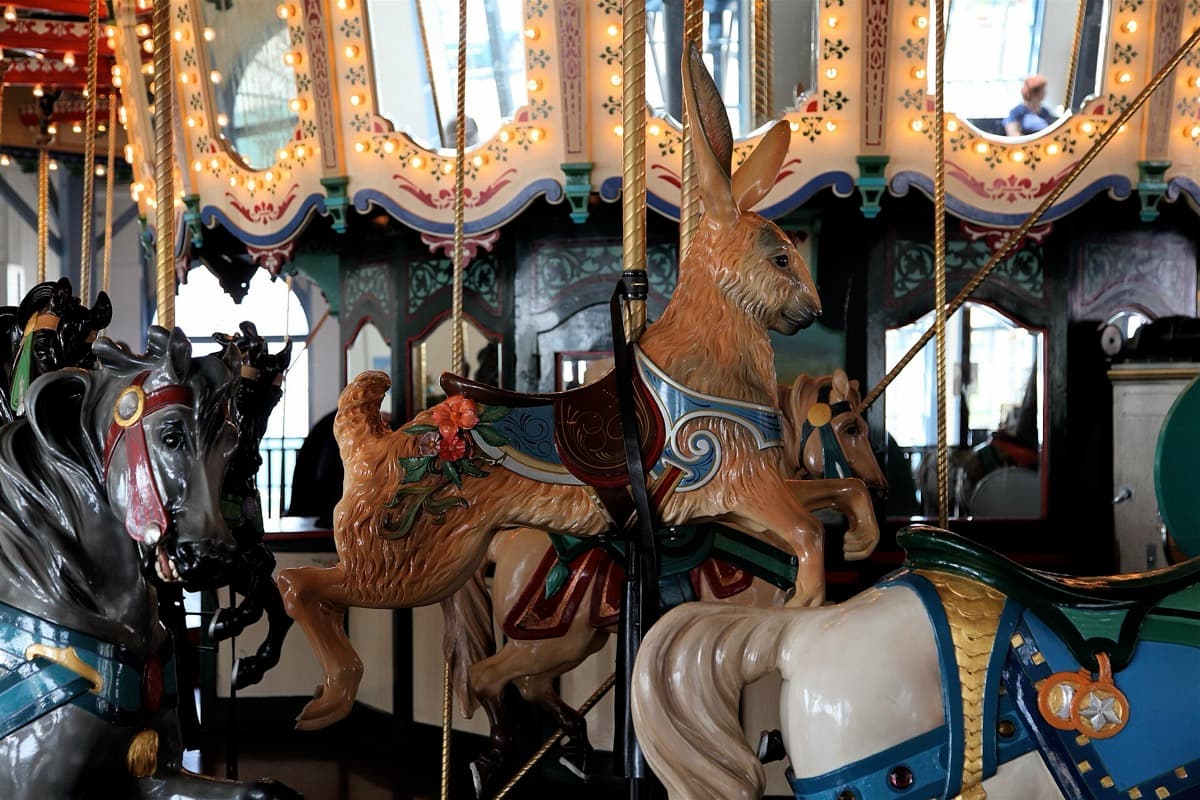 Painted carousel horses under a canopy of lights