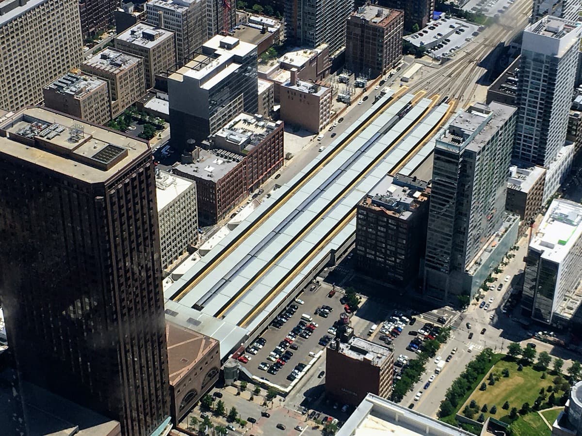 A commuter platform under the glass-and-steel roof of a city station