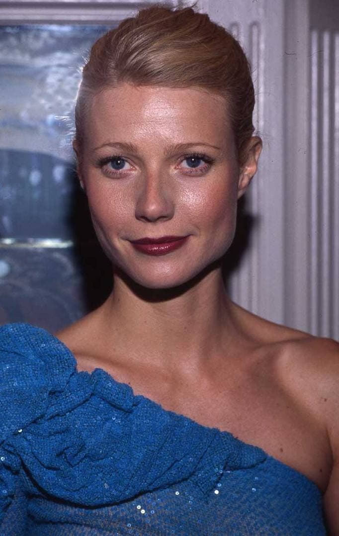 Gwyneth Paltrow with her hair pinned back, in a blue one-shouldered dress