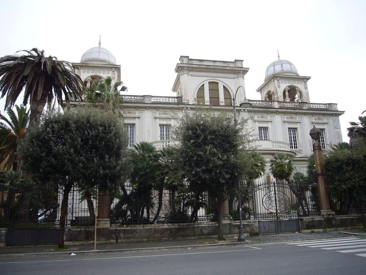 A curved Liberty-style seafront building with domed towers