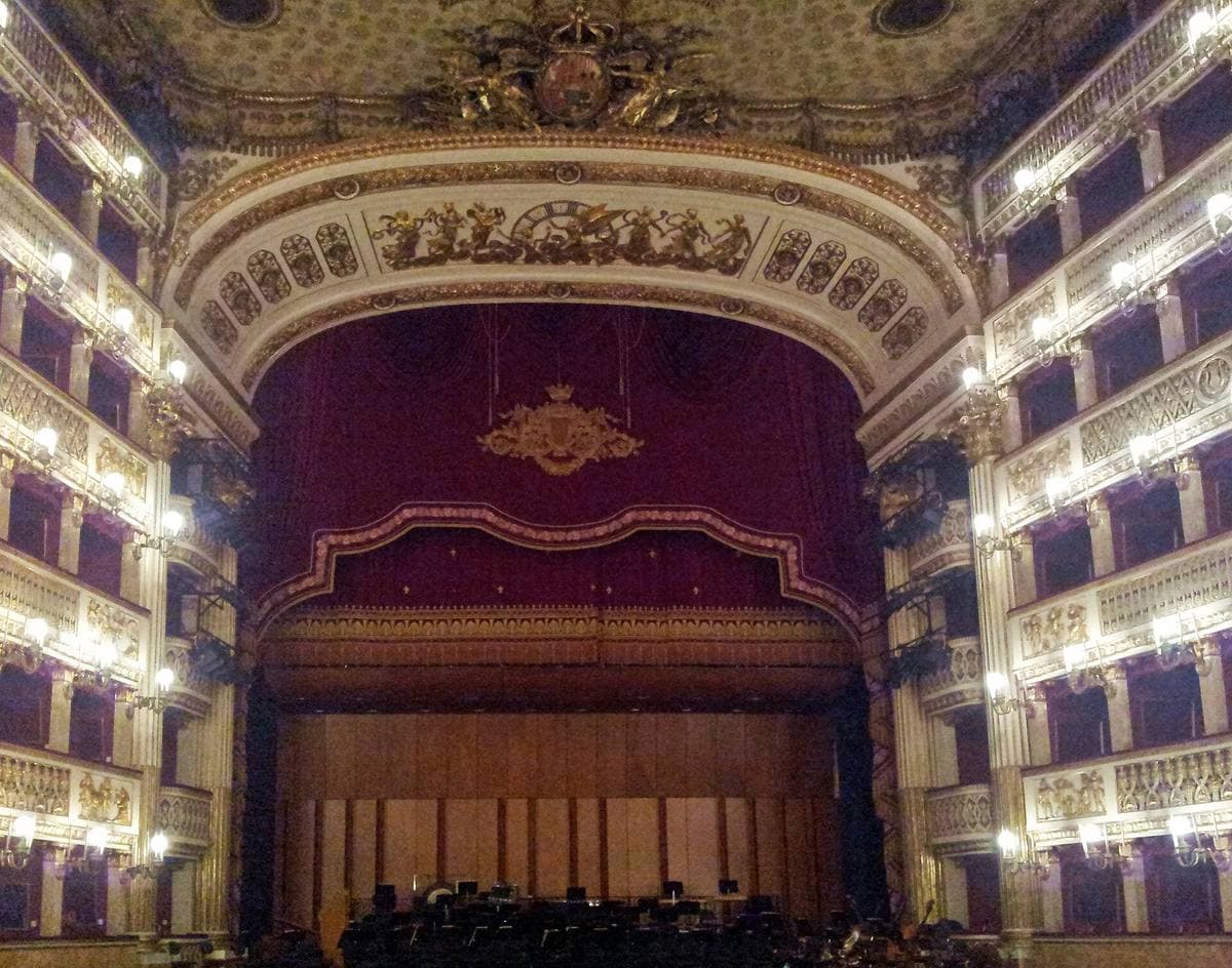 Tiers of red and gold opera boxes rising round a horseshoe auditorium