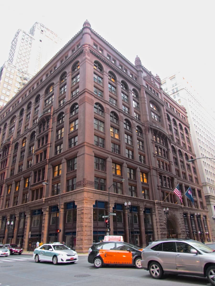A tall brick and stone office building seen from below
